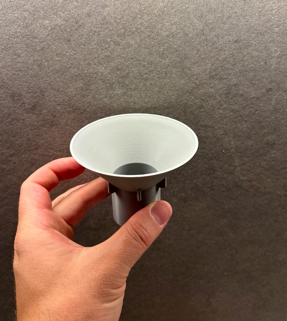 A gray 3D-printed funnel for dishwasher salt